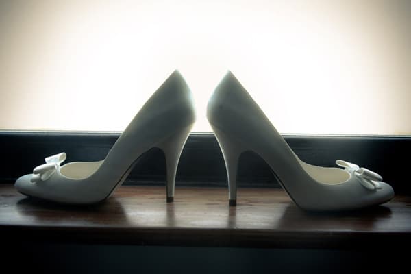 The bride 39s wedding shoes in natural light from a window